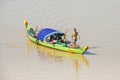 Long-tail wooden boat with a Cambodian family living on it