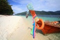 Long tail wooden boat with colorful ribbons