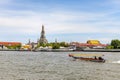 A long-tailed boat is sailing on the Chao Phraya River. It\'s a quick water journey in Bangkok