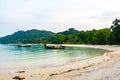 Long tailed boats near tropical beach at Ko Phi Phi, Thailand. Tropic beach with white sand and turquoise water, concept of Royalty Free Stock Photo