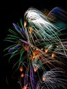 Long term color exposure of New Year night celebration firework in pink, white, golden and violet on black background Royalty Free Stock Photo