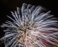 Long term exposure image of New Year night celebration single isolated firework explosion in silver, red and yellow on black Royalty Free Stock Photo