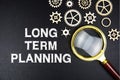 Long Term Planning text message with magnifying glass on black background Royalty Free Stock Photo
