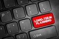 Long-term planning text on a red keyboard button, concept of future focused strategy, financial and health planning, goal setting Royalty Free Stock Photo