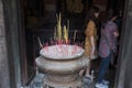 Long thin candles with incense in a special vessel