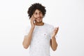 Long time no see, nice hear you mate. Friendly carefree good-looking dark-skinned man with afro haircut, gesturing and Royalty Free Stock Photo