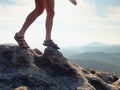 Long tired naked legs in hiking sandals on peak. Hiking in sandstone rocks, hilly landscape Royalty Free Stock Photo