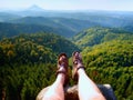 Long tired naked legs in hiking sandals on peak. Hiking in sandstone rocks, hilly landscape Royalty Free Stock Photo