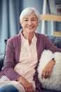 Long in the tooth but youthful at heart. Cropped portrait of a happy senior woman relaxing comfortably on her couch at Royalty Free Stock Photo