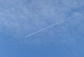 A long trail of jet plane on blue sky Royalty Free Stock Photo