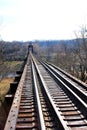 Long trestle railroad tracks across a small river Royalty Free Stock Photo