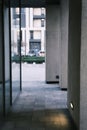 Long tunnel with columns and mirrors in modern city architecture with low lights and grey colors with tile on the frloor