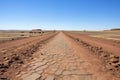 a long view of a desolate walking path at a camp