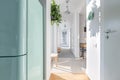 White corridor with modern lightning, wooden furniture, green plant and armchair Royalty Free Stock Photo