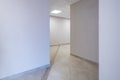 Long white empty corridor in interior of entrance hall of modern apartments, office or clinic