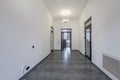 Long white empty corridor in interior of entrance hall of modern apartments, office or clinic