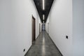 Long white empty corridor in interior of entrance hall of modern apartments, office or clinic