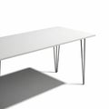 A Long White Rectangular Table with Thin Black Metal Hairpin Legs on a White Background Royalty Free Stock Photo