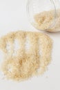 Long white rice on a white background. Spilled from a jar Royalty Free Stock Photo