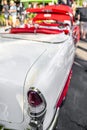 Long white vintage retro convertible car with red leather trim and seats exhibited at a provincial town street exhibition Royalty Free Stock Photo
