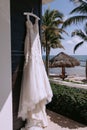Long white wedding dress on a hanger outdoors Royalty Free Stock Photo