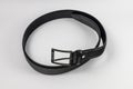 Long and wide black leather belt with few small holes and metallic big buckle