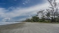 A long and wide sandy beach by the ocean. Malaysia. Borneo. Royalty Free Stock Photo