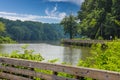 a long winding boardwalk along the river with a wooden rail along the sides with vast still river water, lush green trees Royalty Free Stock Photo