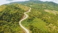 A long and winding road passing through green hills. Busuanga island. Coron. Aerial view. Philippines. Royalty Free Stock Photo