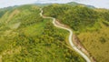 A long and winding road passing through green hills. Busuanga island. Coron. Aerial view. Philippines. Royalty Free Stock Photo