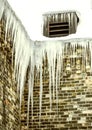 Long Winter Icicles Hanging From Brick Building