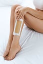 Long Woman Legs With Hair Wax Strip Closeup. Hair Removal Royalty Free Stock Photo