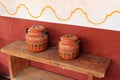 Long wood bench with colorful clay pots Royalty Free Stock Photo