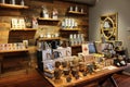 Long wood tables and shelves displaying products in local shop, Saratoga Tea & Honey, New York, 2019