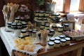 Long wood tables and shelves displaying products in local shop, Saratoga Tea & Honey, New York, 2019