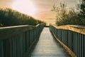 A long wooden boadwalk seems to stretch to infinity. Walkway through the lake and native forest, Oceano, California Royalty Free Stock Photo