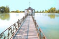 A long wooden bridge on the lake.There is a gazebo at the end of the bridge. Royalty Free Stock Photo