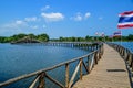 A long wooden bridge leading to a large water storage area made of cedar wood at chumphon , Thailand