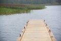 Long wooden dock on the lake Royalty Free Stock Photo