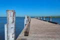 Long wooden jetty, pier with blue ocean and clear sky Royalty Free Stock Photo