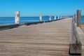 Long wooden jetty, pier with blue ocean and clear sky Royalty Free Stock Photo