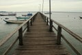 Long Wooden Pier and Beautiful Islands. Low angle view of wooden jetty reaching into the turquoise Indian Ocean waters Royalty Free Stock Photo