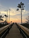 Long wooden walkway with sunset skies