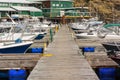 Long wooden wharf with tied boats