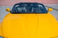Long yellow hood sports two-seater convertible. Close up. Royalty Free Stock Photo