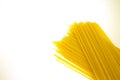 Long yellow raw spaghetti isolated on white background