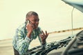 That long. a young man calling roadside assistance after breaking down. Royalty Free Stock Photo