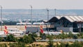 Long zoom view of airplanes on tarmac and iconic roof of Bajaras Airport in Madrid, Spain