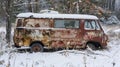 A longabandoned van sits snowcovered its windows cracked and long forgotten by its owner Royalty Free Stock Photo