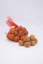 Longan fruit in red plastic basket on white background